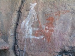 Rock art at Anbangbang Gallery of a hunter and kangaroo.