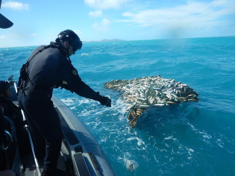 Attaching a tracker to a ghost net. Credit: Australian Fisheries Management Authority