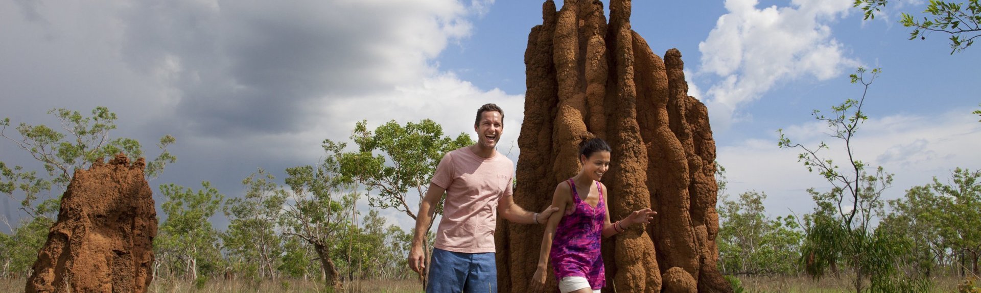 Visitors beside termite mounds. Photo: Peter Eve, Tourism NT