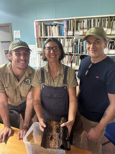 Staff showing the newly arrived snails.