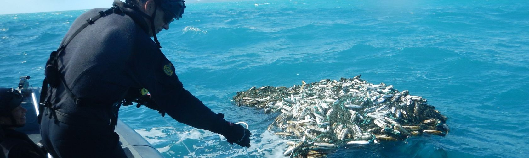 Attaching a tracker to a ghost net. Credit: Australian Fisheries Management Authority