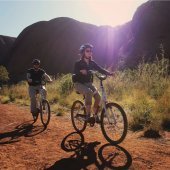 Cycling the base of Uluru. Photo: Tourism NT