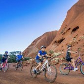 Cycling the base of Uluru. Photo: Outback Cycling